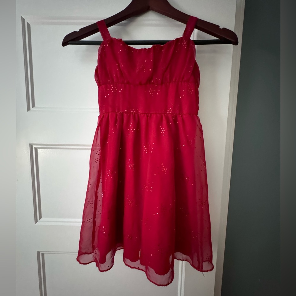 She’s the 1 red polyester dress with zipper in backer. Size 7